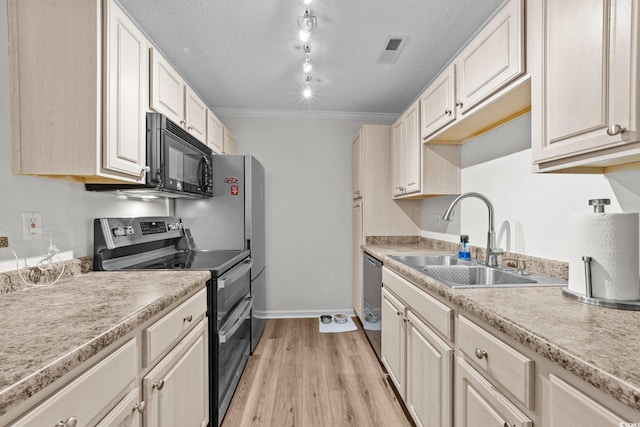 kitchen featuring stainless steel appliances, a sink, light wood-type flooring, light countertops, and crown molding