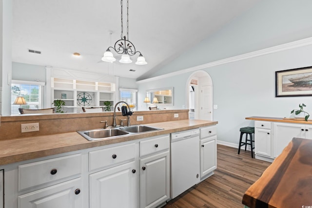 kitchen featuring white dishwasher, a sink, white cabinets, vaulted ceiling, and dark wood finished floors