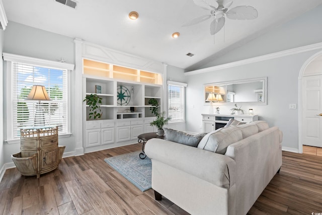 living area featuring a ceiling fan, lofted ceiling, wood finished floors, healthy amount of natural light, and baseboards