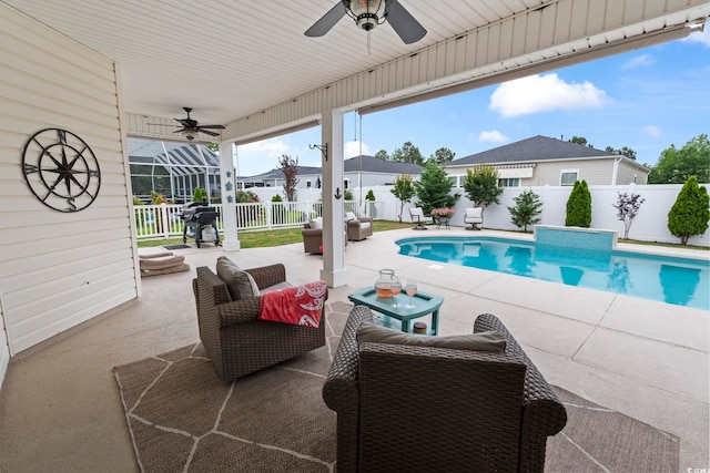 view of swimming pool with ceiling fan, a fenced backyard, and a patio