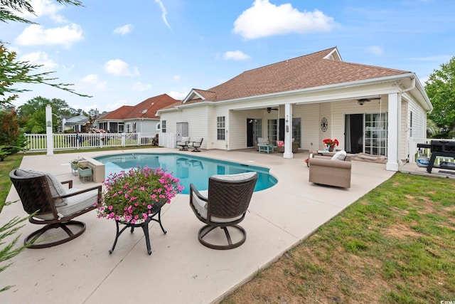 view of swimming pool with fence, a patio, a ceiling fan, and an outdoor hangout area