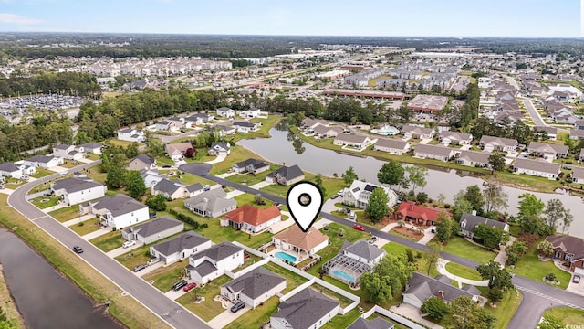 aerial overview of property's location with a large body of water and nearby suburban area
