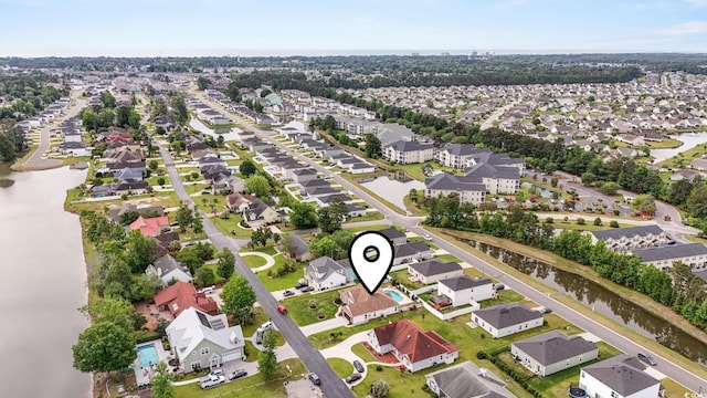 aerial view of residential area featuring a large body of water