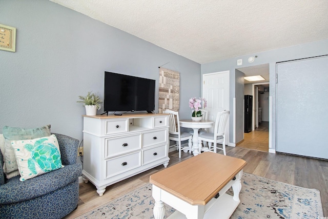 living room featuring light wood-style floors and a textured ceiling