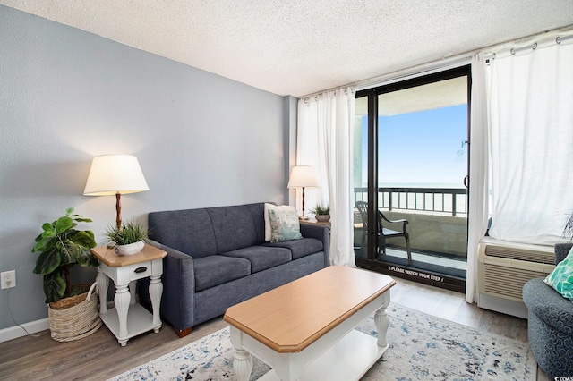 2311 S Ocean Blvd Unit 559, Myrtle Beach, SC 29577 - living room featuring wood finished floors, a water view, a textured ceiling, and baseboards