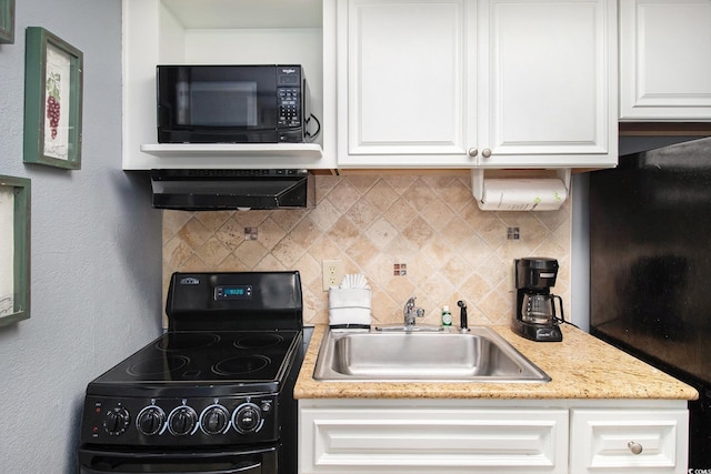 kitchen with black appliances, a sink, backsplash, and white cabinetry