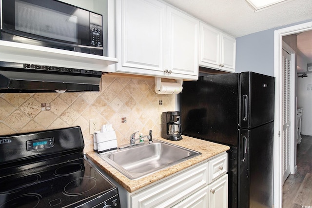 2311 S Ocean Blvd Unit 559, Myrtle Beach, SC 29577 - kitchen with black appliances, a sink, white cabinetry, and wood finished floors