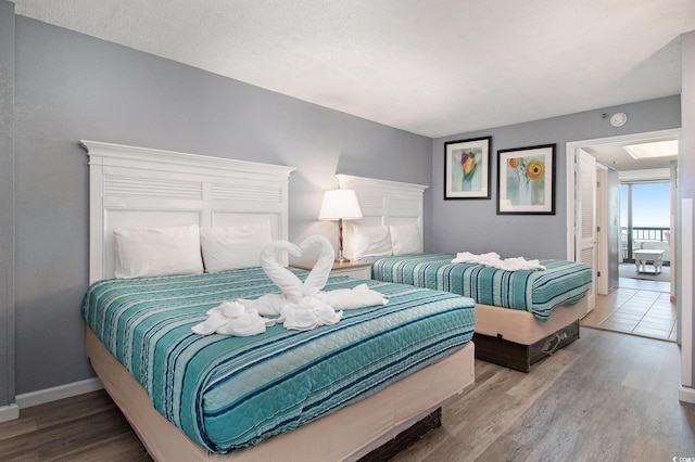 bedroom with wood finished floors and baseboards