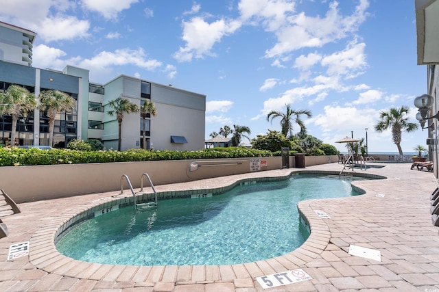 community pool with a patio area