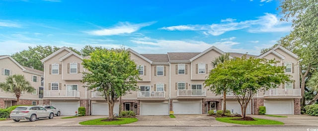 601 Hillside Dr N Unit 302, North Myrtle Beach, SC 29582 - view of front facade with a garage, driveway, and brick siding