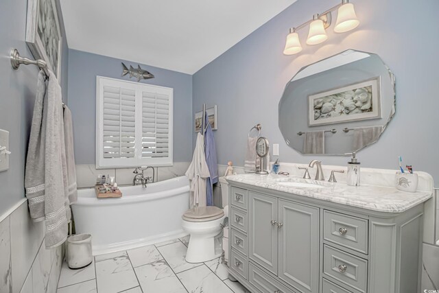 601 Hillside Dr N Unit 302, North Myrtle Beach, SC 29582 - bathroom with a freestanding tub, marble look tiles, vanity, and toilet