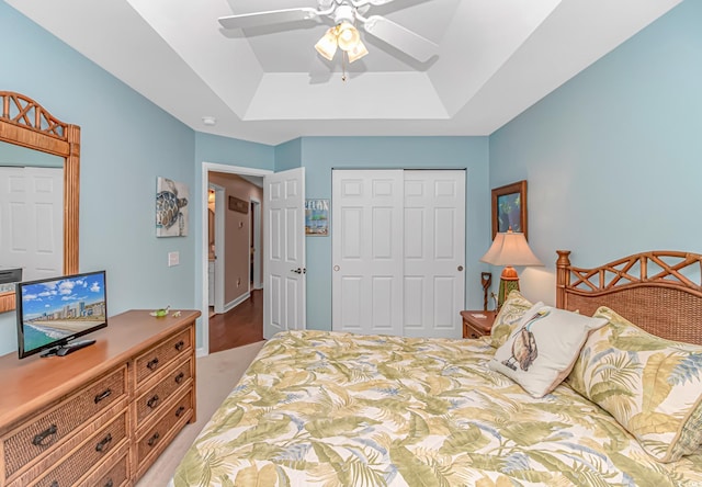 601 Hillside Dr N Unit 302, North Myrtle Beach, SC 29582 - bedroom featuring a raised ceiling, a closet, a ceiling fan, and light carpet