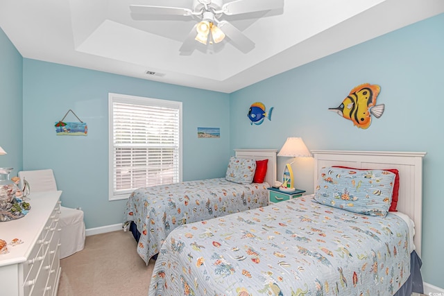 601 Hillside Dr N Unit 302, North Myrtle Beach, SC 29582 - bedroom with light colored carpet, baseboards, a tray ceiling, and a ceiling fan