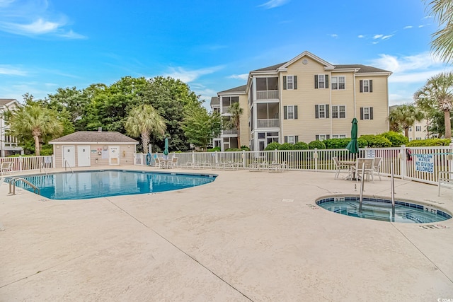 601 Hillside Dr N Unit 302, North Myrtle Beach, SC 29582 - community pool featuring a community hot tub, a patio area, and fence