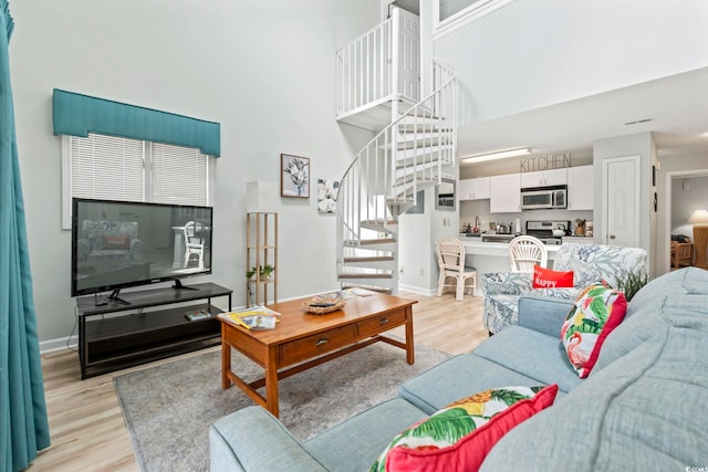 207 Double Eagle Dr Unit F-3, Myrtle Beach, SC 29575 - living area with a towering ceiling, stairway, and light wood-style floors