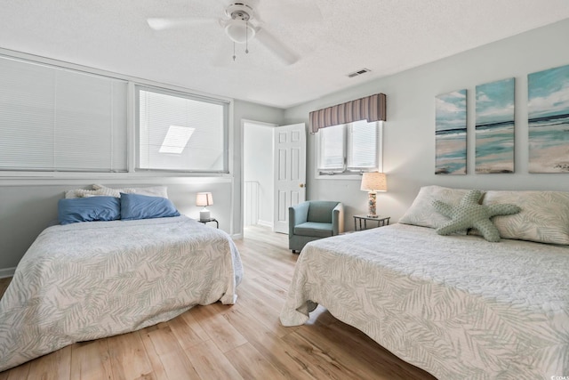 207 Double Eagle Dr Unit F-3, Myrtle Beach, SC 29575 - bedroom featuring wood finished floors, a textured ceiling, and ceiling fan