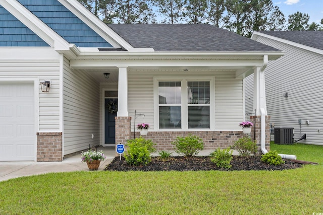 2405 Capri Ct, Conway, SC 29527 - view of exterior entry with brick siding, a porch, a lawn, and central air condition unit