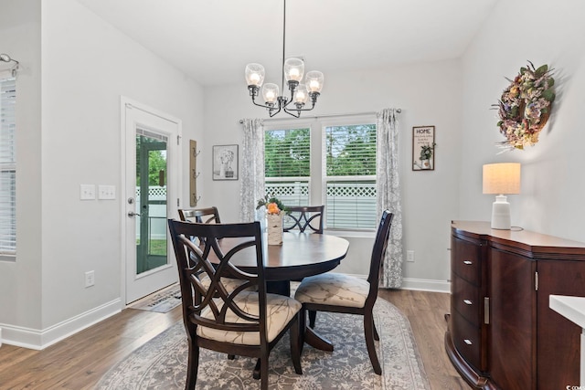 2405 Capri Ct, Conway, SC 29527 - dining space featuring wood finished floors, baseboards, and a chandelier