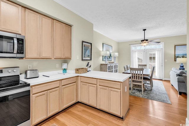 kitchen with stainless steel appliances, light brown cabinetry, ornamental molding, a peninsula, and light wood-style flooring