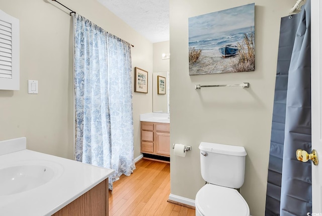 bathroom featuring vanity, hardwood / wood-style floors, and toilet