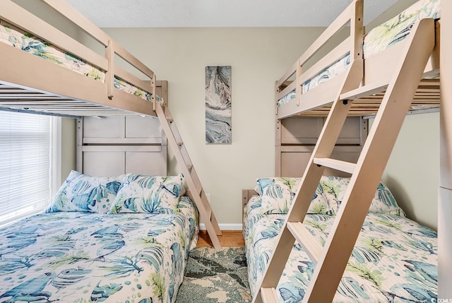bedroom with wood finished floors and baseboards