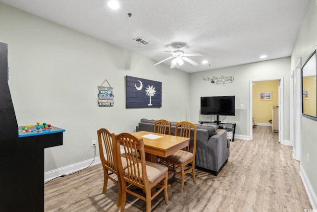 dining area with a ceiling fan, light wood-style floors, recessed lighting, and baseboards