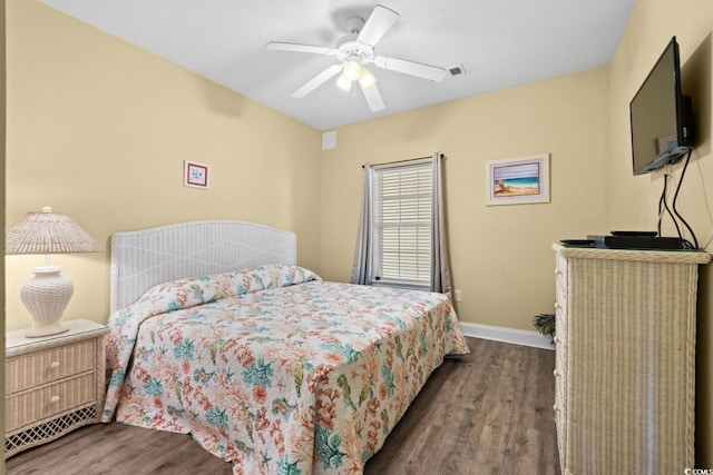 bedroom featuring wood finished floors, baseboards, and a ceiling fan