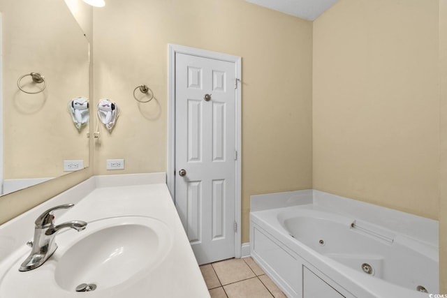 bathroom featuring tile patterned floors, a tub with jets, and vanity