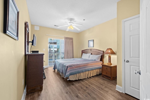 bedroom with wood finished floors, access to outside, baseboards, and ceiling fan