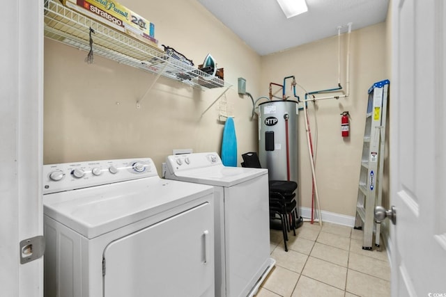 washroom with washer and clothes dryer and light tile patterned floors