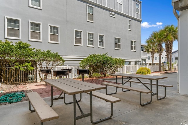 view of community featuring a patio and fence