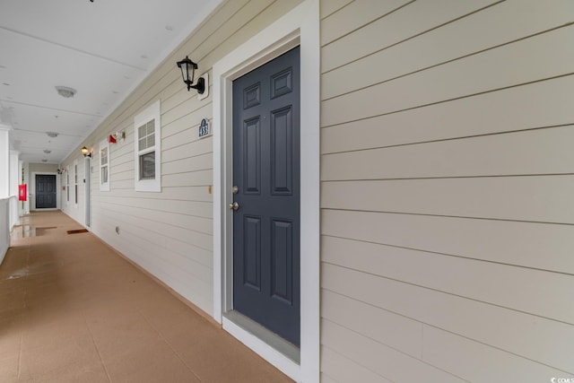 view of exterior entry featuring a porch