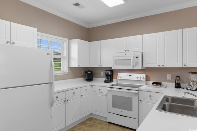 kitchen with white appliances, a sink, crown molding, and white cabinetry