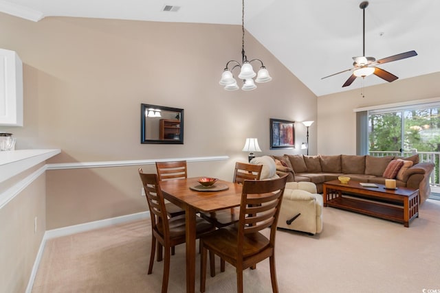 dining room featuring light carpet, ceiling fan, baseboards, high vaulted ceiling, and a chandelier