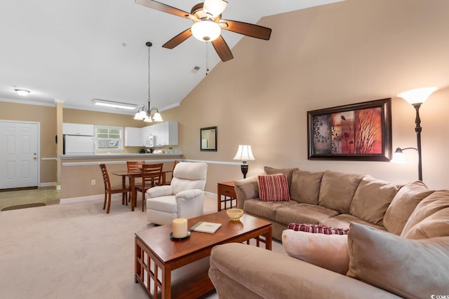 living area with baseboards, a ceiling fan, a chandelier, lofted ceiling, and light carpet