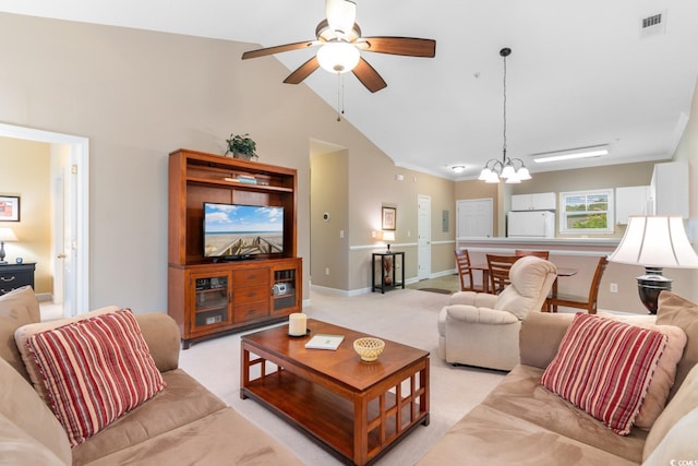 living area featuring vaulted ceiling, ceiling fan, a chandelier, light colored carpet, and baseboards