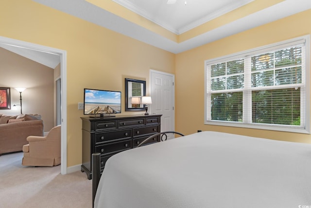 bedroom with ornamental molding, light carpet, baseboards, and ceiling fan
