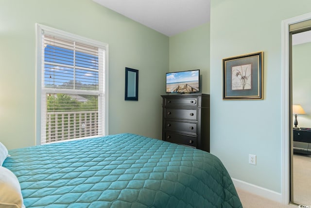 bedroom with carpet and baseboards