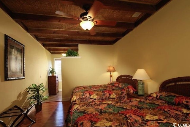 bedroom featuring wood finished floors and baseboards