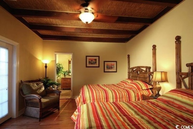 bedroom featuring beam ceiling and wood finished floors