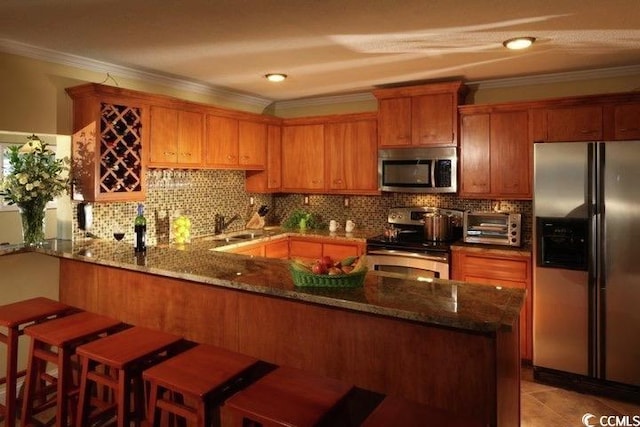 kitchen with stainless steel appliances, a peninsula, crown molding, dark stone counters, and tasteful backsplash