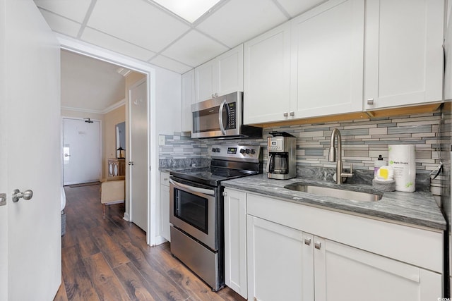 1105 S Ocean Blvd Unit 724, Myrtle Beach, SC 29577 - kitchen featuring stainless steel appliances, a sink, decorative backsplash, stone counters, and white cabinets