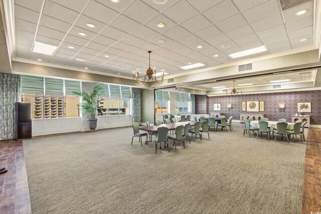1105 S Ocean Blvd Unit 724, Myrtle Beach, SC 29577 - dining area featuring carpet flooring, ornamental molding, a chandelier, wallpapered walls, and a drop ceiling