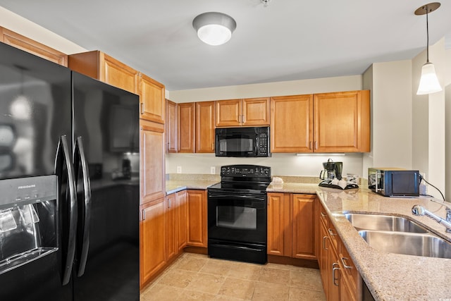 8121 Amalfi Pl Unit 7-604, Myrtle Beach, SC 29572 - kitchen with black appliances, a sink, light stone countertops, hanging light fixtures, and brown cabinets