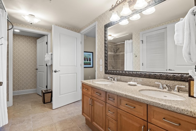 8121 Amalfi Pl Unit 7-604, Myrtle Beach, SC 29572 - bathroom featuring wallpapered walls, double vanity, tiled shower, baseboards, and tile patterned floors