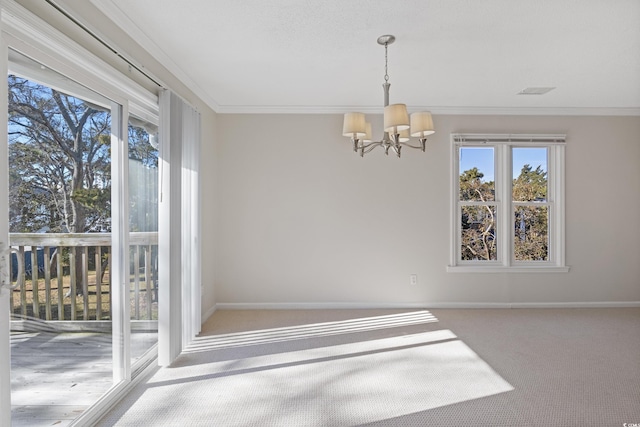 unfurnished dining area featuring plenty of natural light, a chandelier, carpet flooring, baseboards, and crown molding