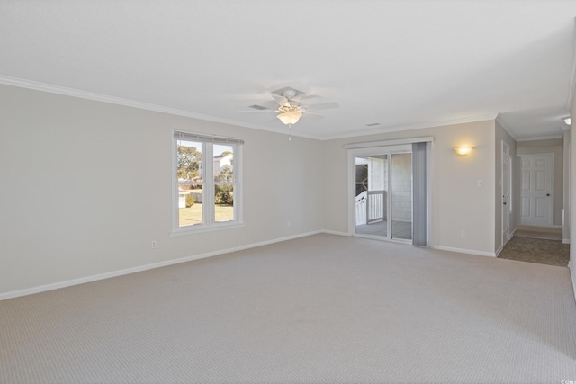 spare room with crown molding, baseboards, light carpet, plenty of natural light, and ceiling fan