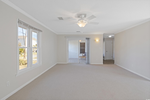 spare room with crown molding, a ceiling fan, baseboards, and light colored carpet