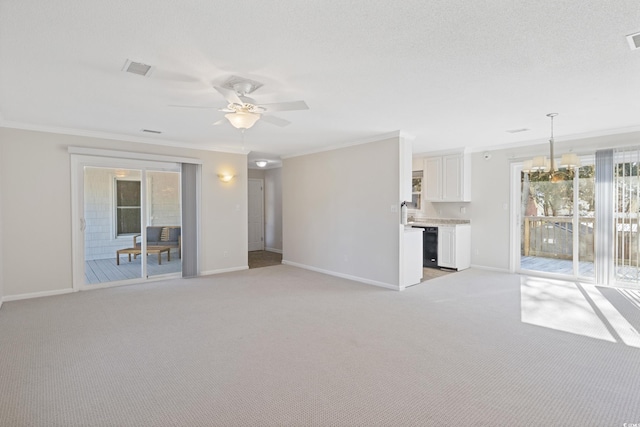unfurnished living room with crown molding, baseboards, a ceiling fan, and light colored carpet