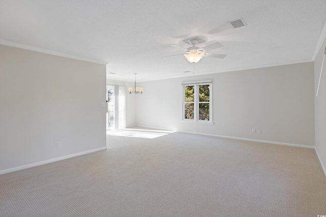 carpeted spare room featuring crown molding, ceiling fan, baseboards, plenty of natural light, and a chandelier